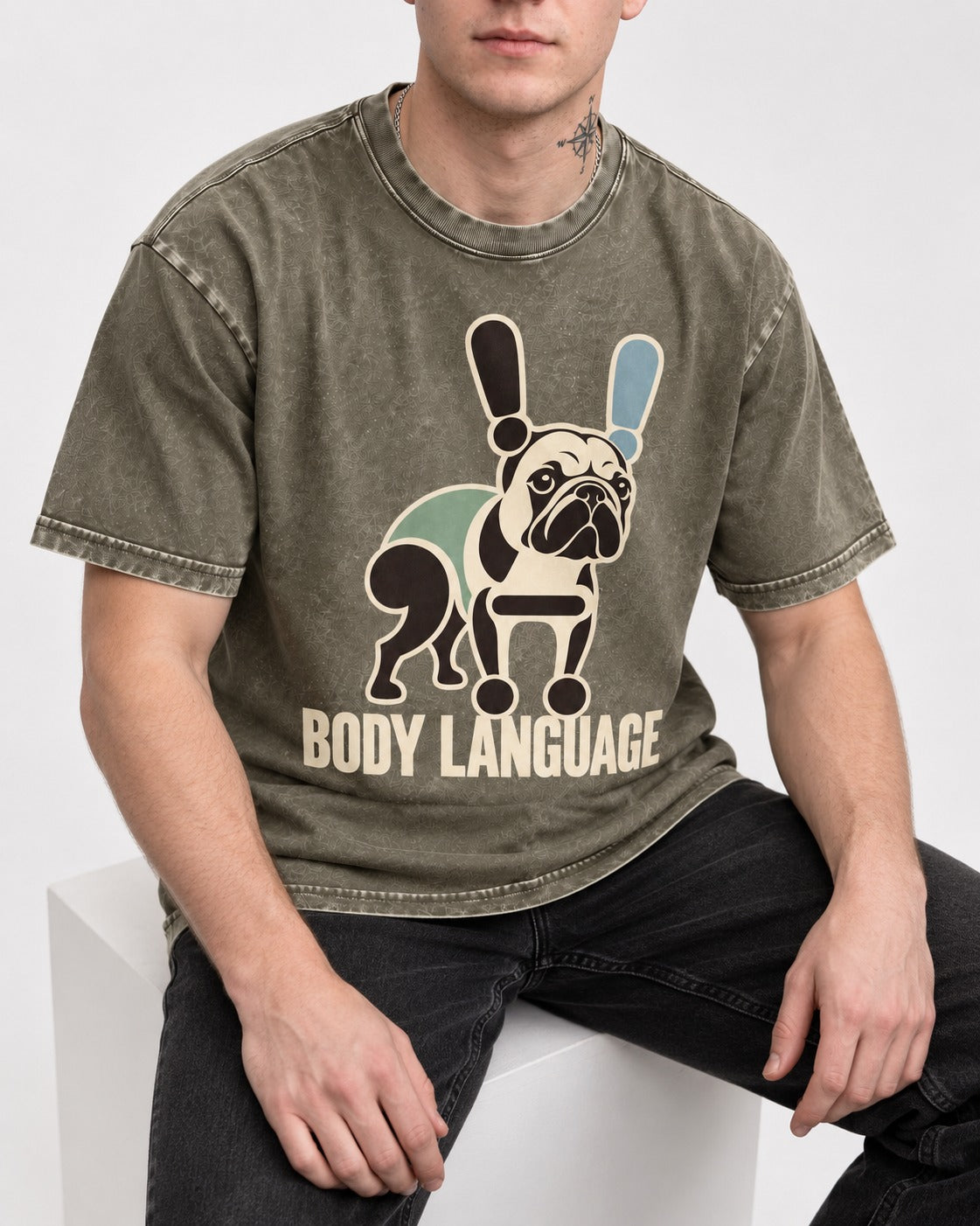 Frenchie Body Language Punctuation Graphic Washed Tee in Army Green, worn by a seated model
