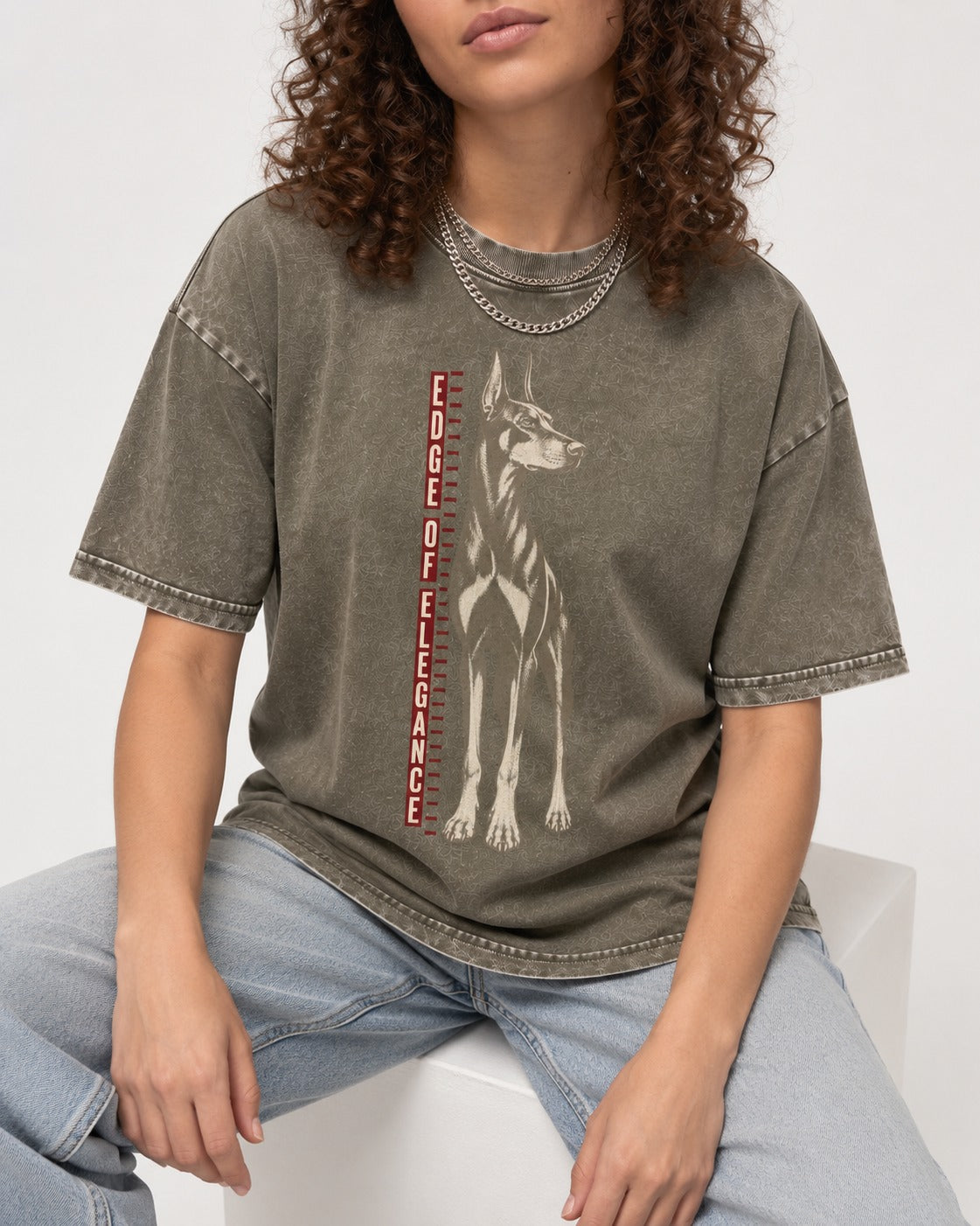 Doberman Edge of Elegance Height Chart Graphic Washed Tee in Army Green, worn by a seated model