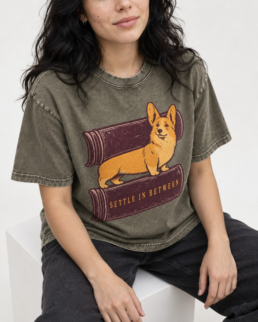 Corgi Settle in Between Washed Tee in Army Green, worn by a seated model