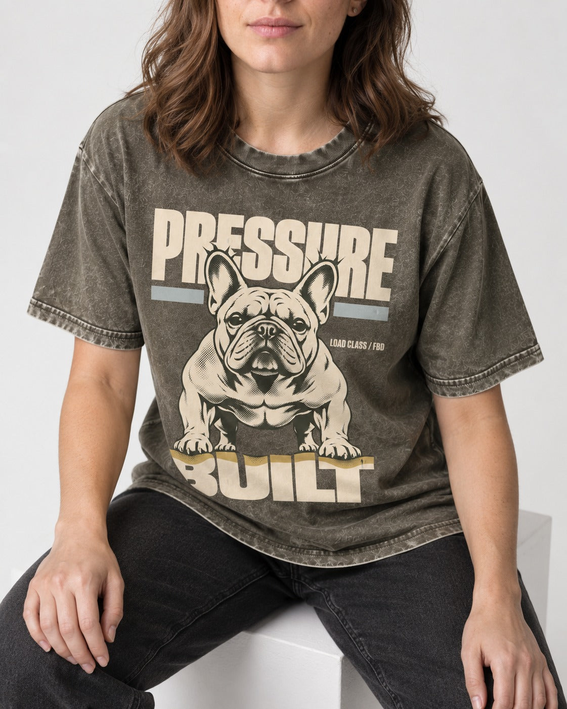 Frenchie Pressure Built Load Class Graphic Washed Tee in Army Green, worn by a seated model