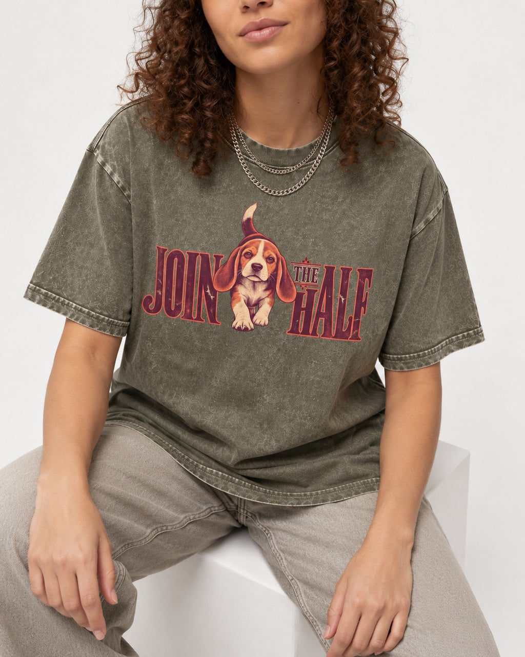 Beagle Join The Half Washed Tee in Army Green, worn by a seated model
