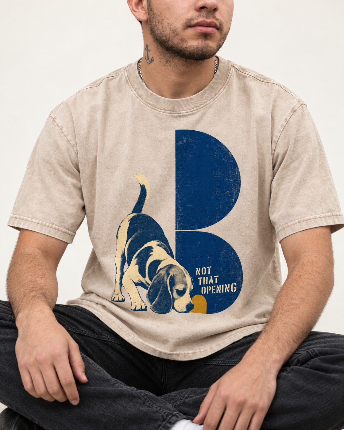 Not That Opening Beagle Washed Tee in Apricot, worn by a seated model
