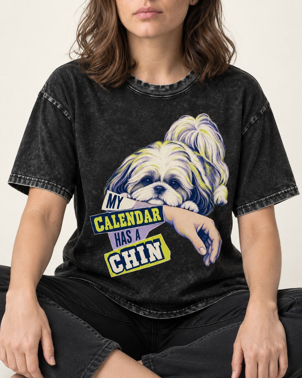 Shih Tzu My Calendar Has a Chin Arm Rest Graphic Washed Tee in Black, worn by a seated model