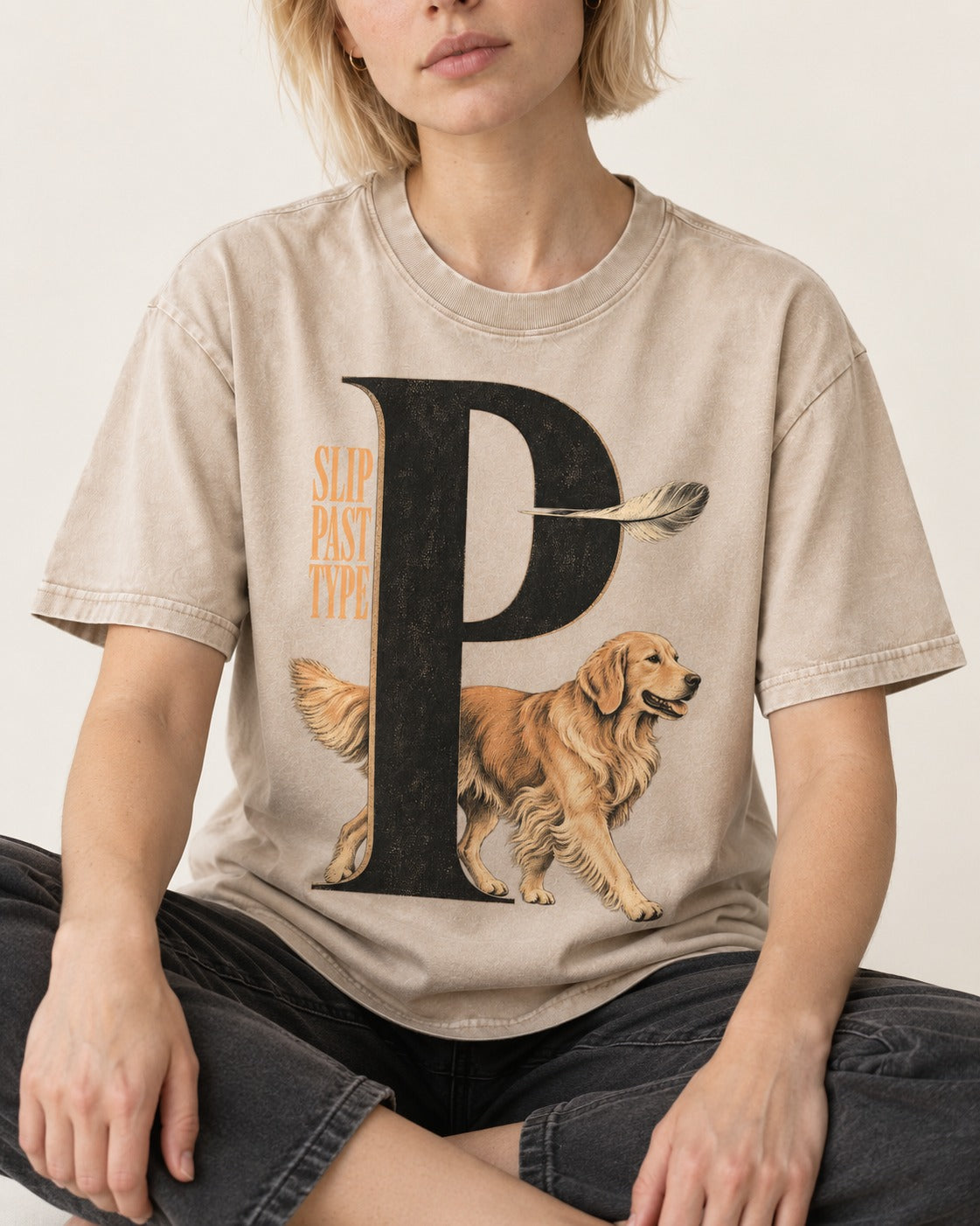 Golden Retriever Slip Past Type Washed Tee in Apricot, worn by a seated model