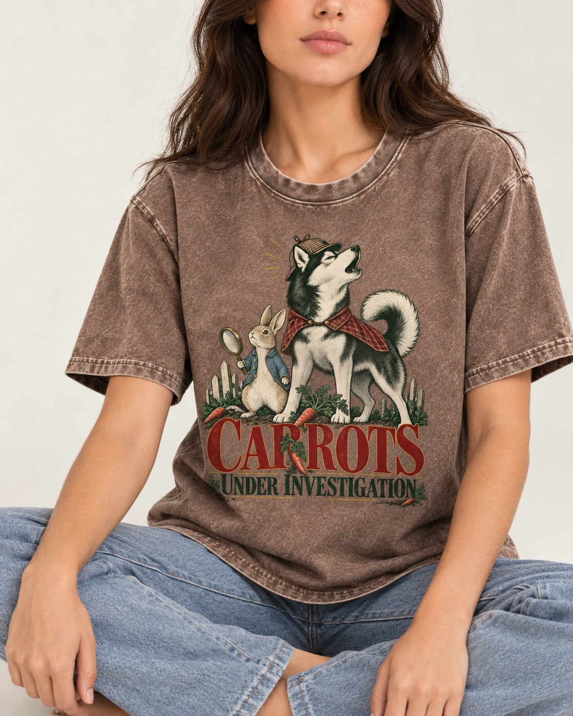 Carrots Under Husky Investigation Washed Tee in Coffee, worn by a seated model