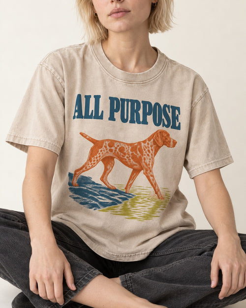 All Purpose German Shorthaired Pointer Washed Tee in Apricot, worn by a seated model