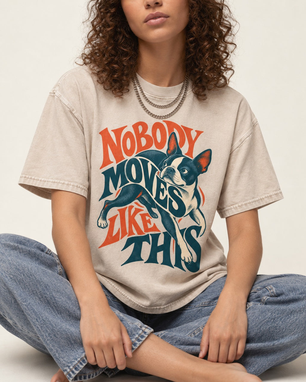 Nobody Moves Like This Boston Terrier Washed Tee in Apricot, worn by a seated model