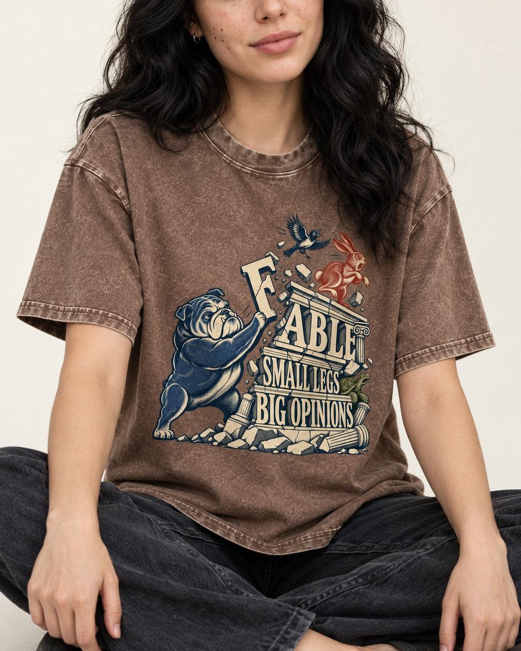 Small Legs Big Opinions English Bulldog Washed Tee in Coffee, worn by a seated model