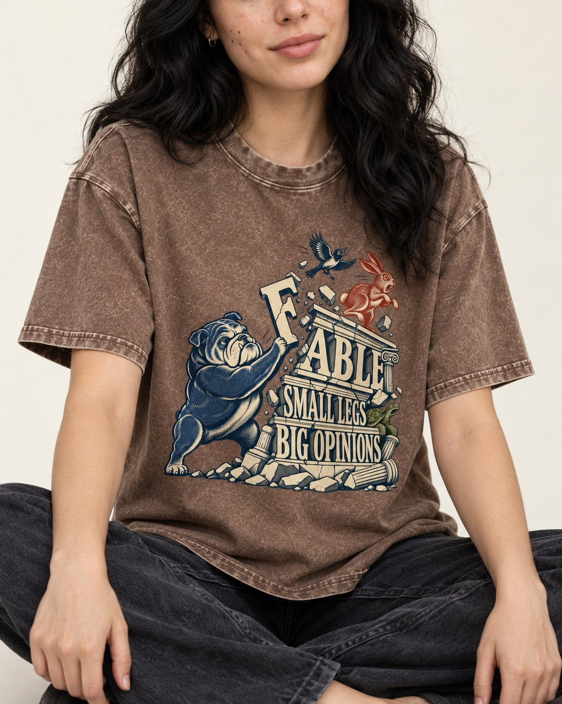 Small Legs Big Opinions English Bulldog Washed Tee in Coffee, worn by a seated model