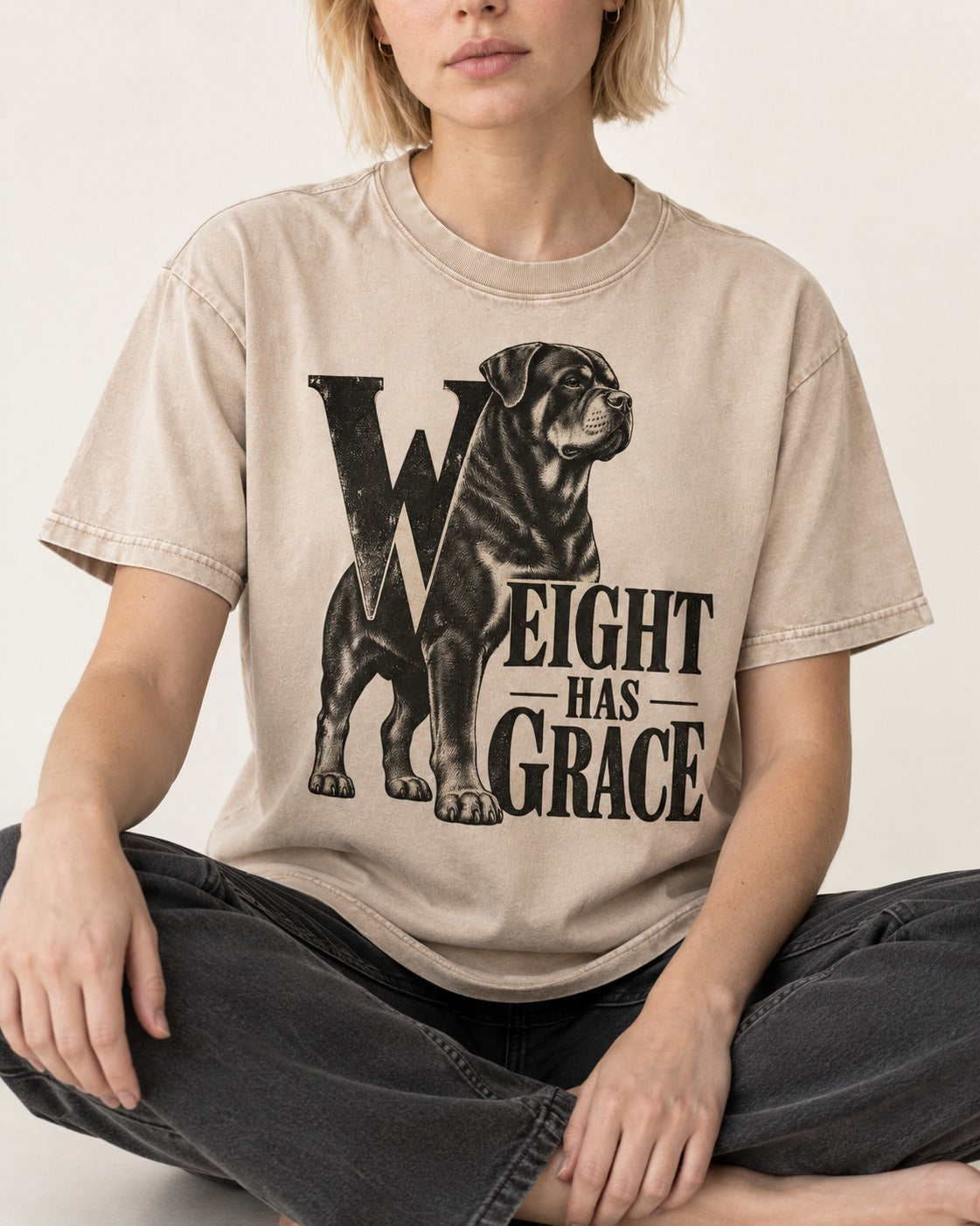 Rottweiler Weight Has Grace Washed Tee in Apricot, worn by a seated model