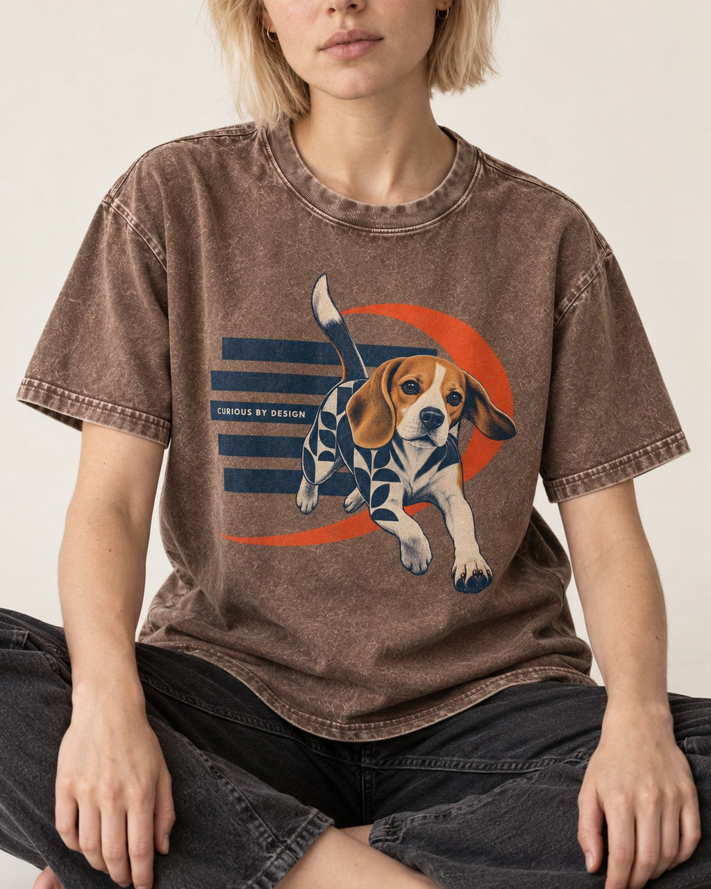 Beagle Born Curious Washed Tee in Coffee, worn by a seated model