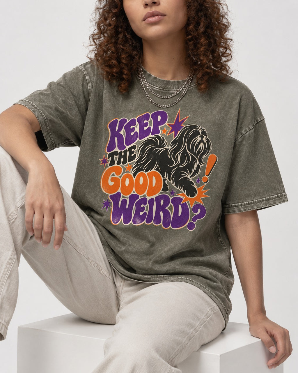 Shih Tzu Keep the Good Weird Retro Typography Graphic Washed Tee in Army Green, worn by a seated model