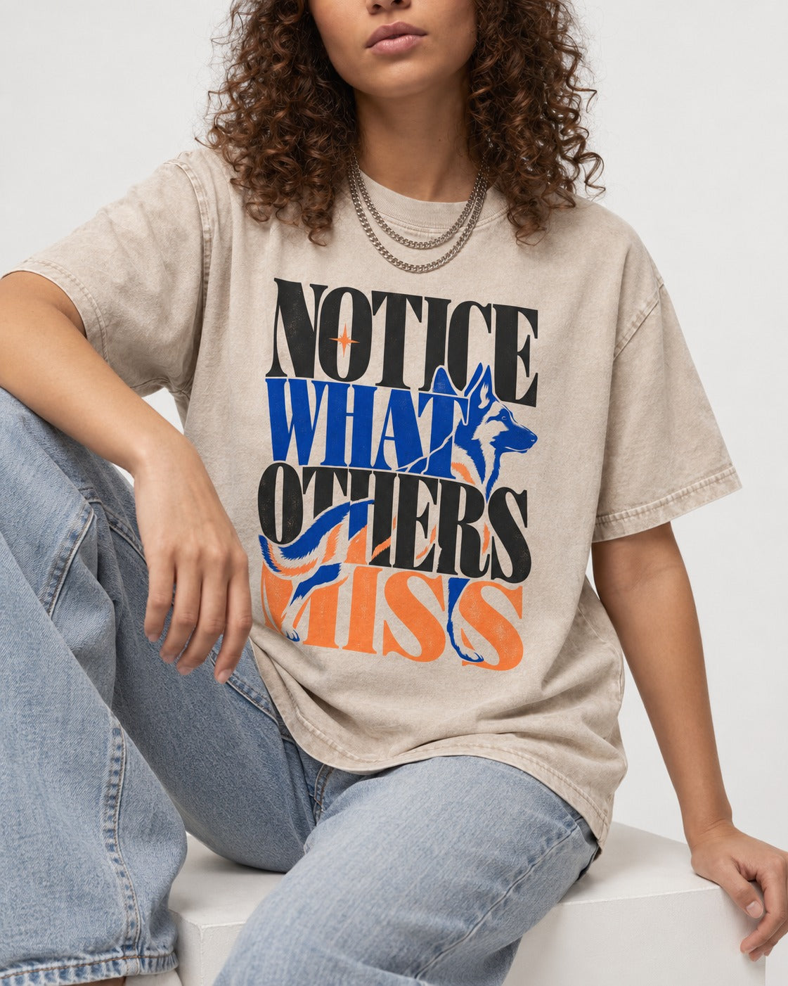Notice What Others Miss German Shepherd Dog Washed Tee in Apricot, worn by a seated model