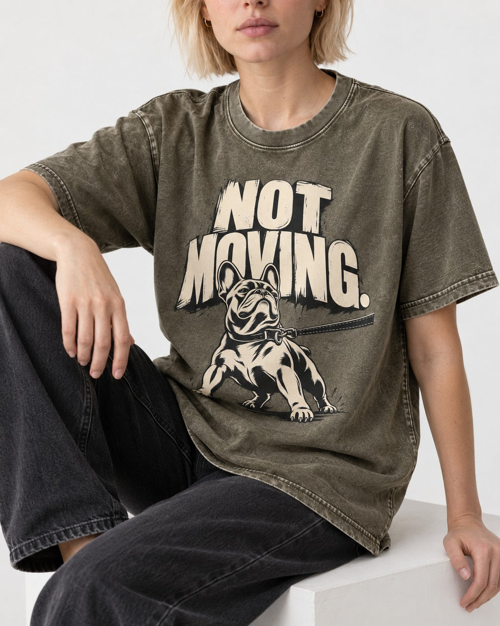 Frenchie Not Moving Taut Leash Poster Washed Tee in Army Green, worn by a seated model