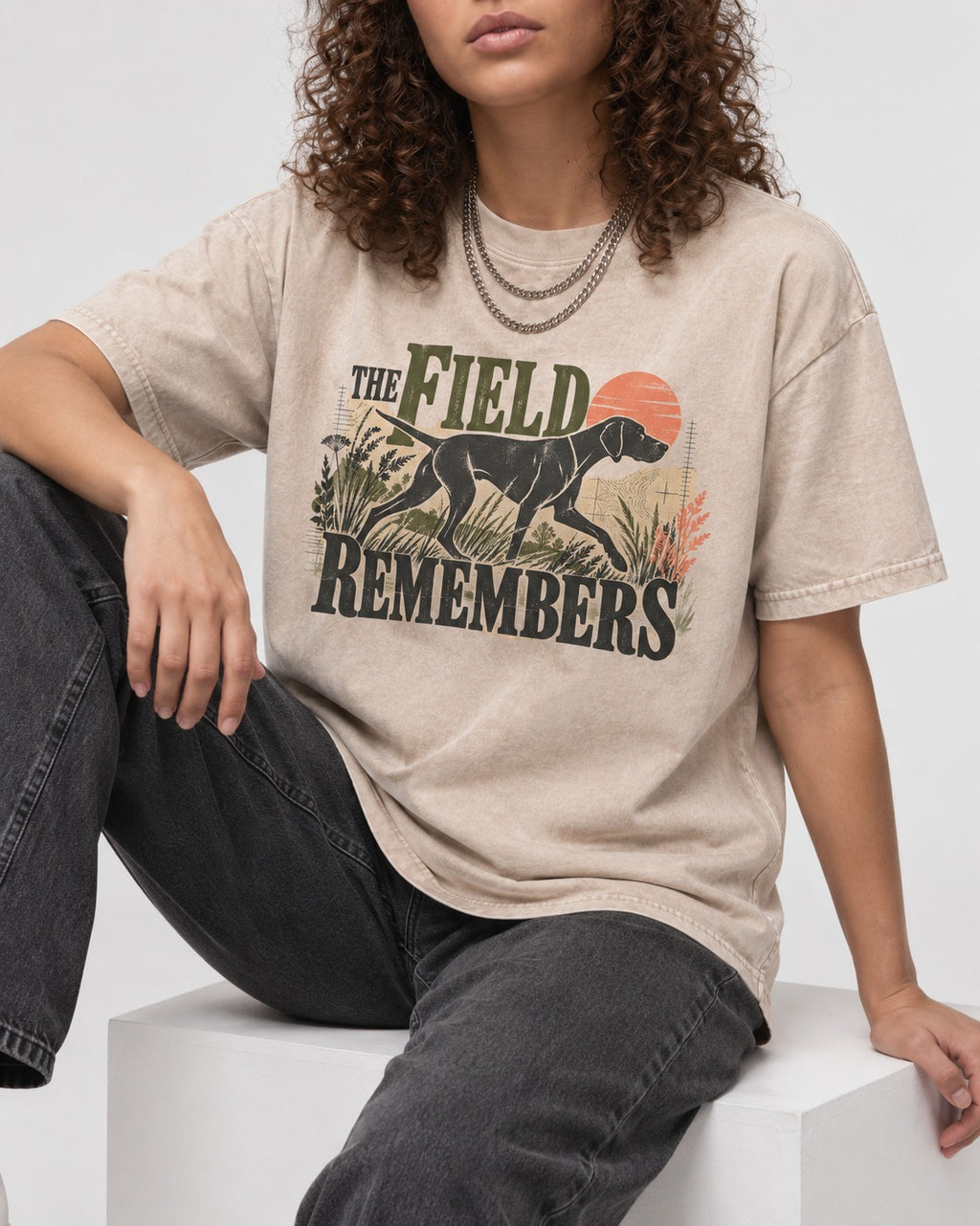 The Field Remembers German Shorthaired Pointer Washed Tee in Apricot, worn by a seated model