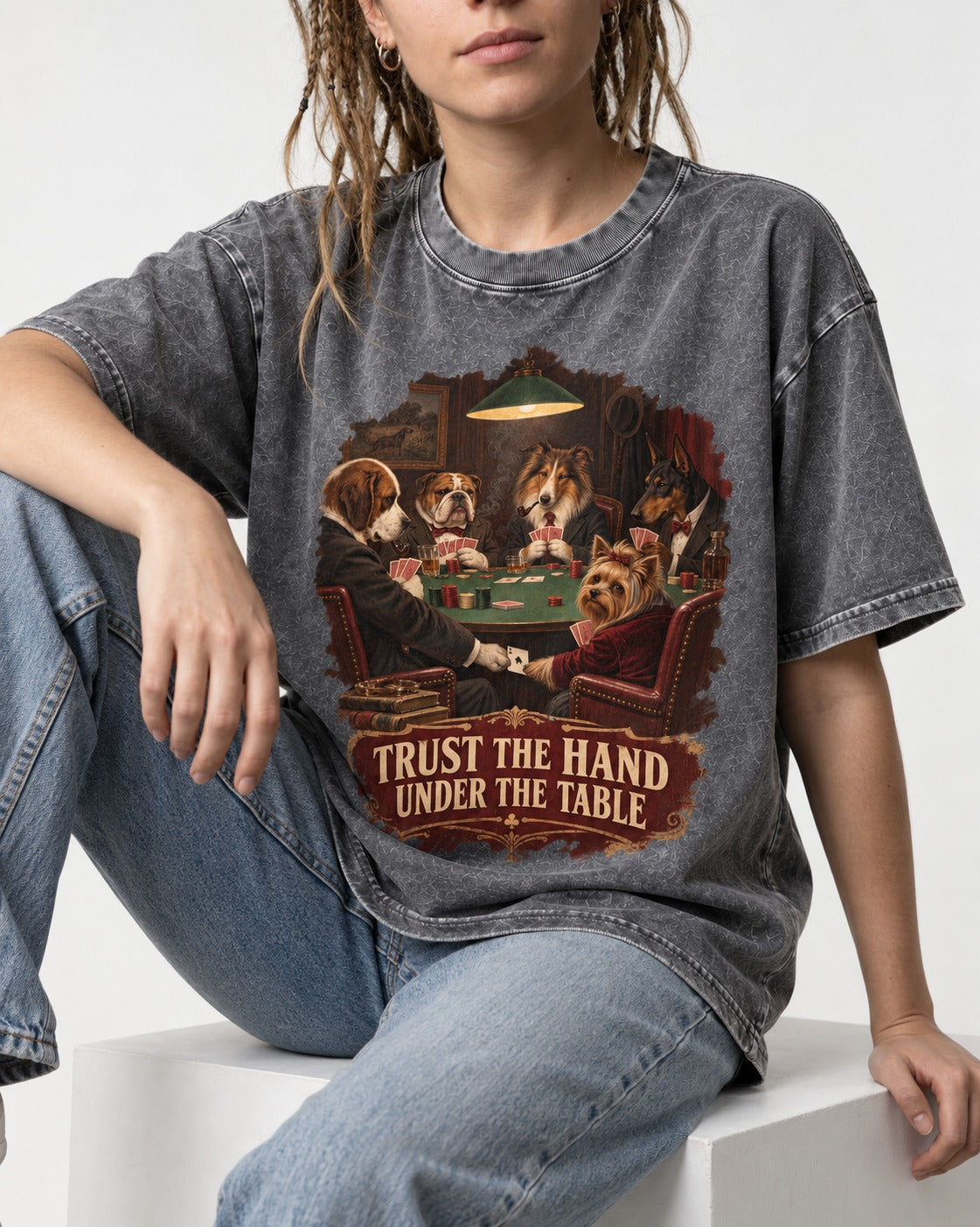 Yorkshire Terrier Trust the Hand Under the Table Poker Dogs Graphic Washed Tee in Gray, worn by a seated model