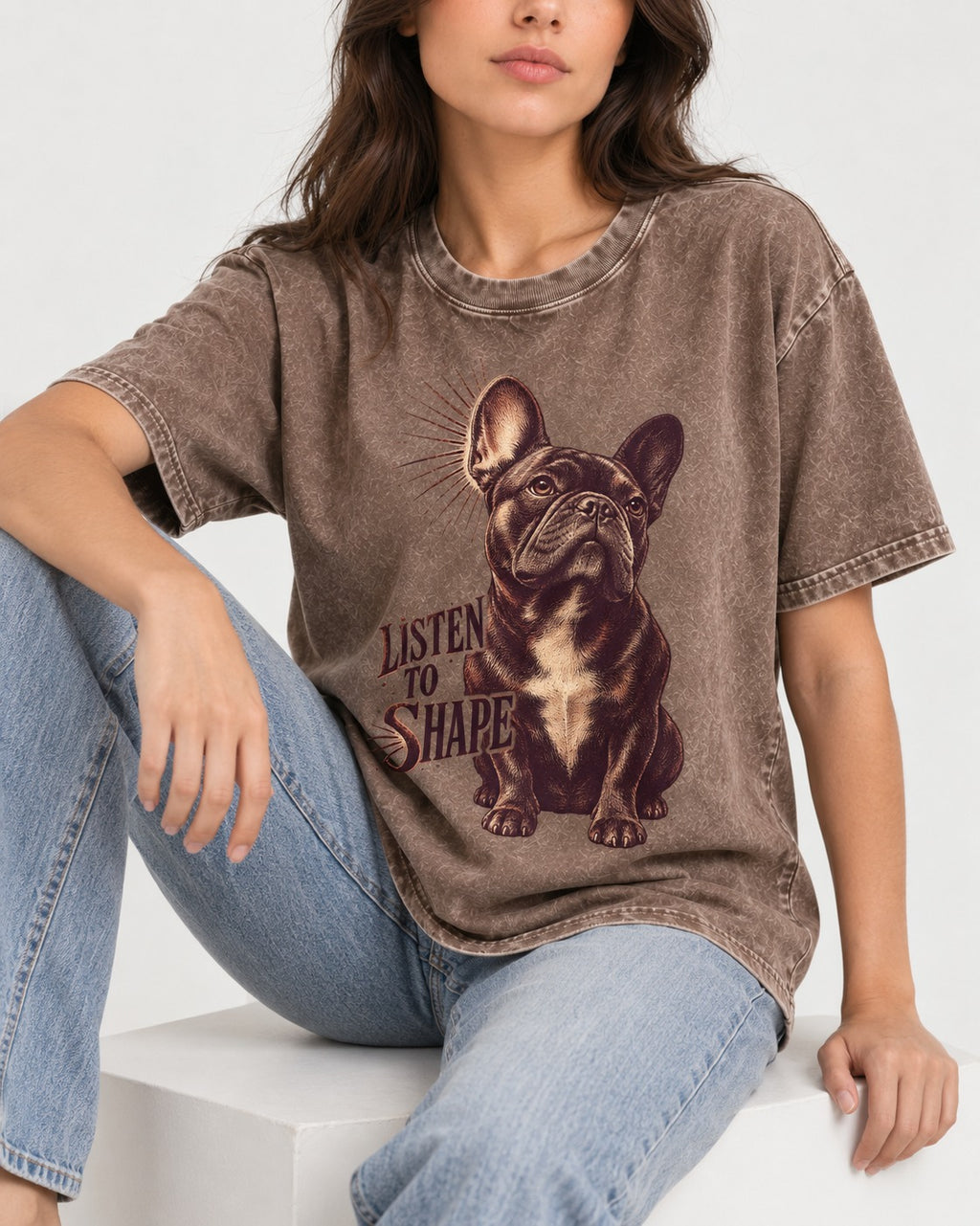 Listen to Shape Frenchie Washed Tee in Coffee, worn by a seated model