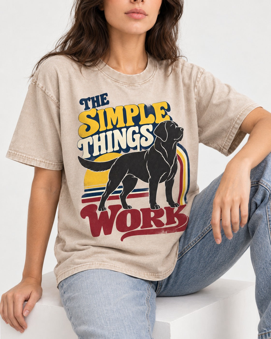 The Simple Things Work Labrador Retriever Washed Tee in Apricot, worn by a seated model