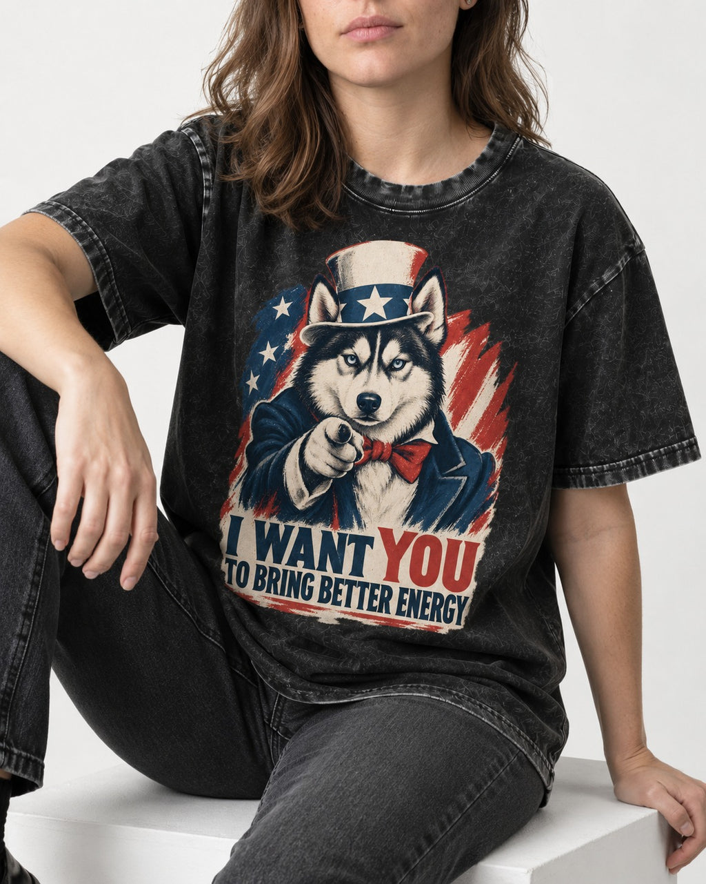 Husky I Want You to Bring Better Energy Patriotic Poster Graphic Washed Tee in Black, worn by a seated model