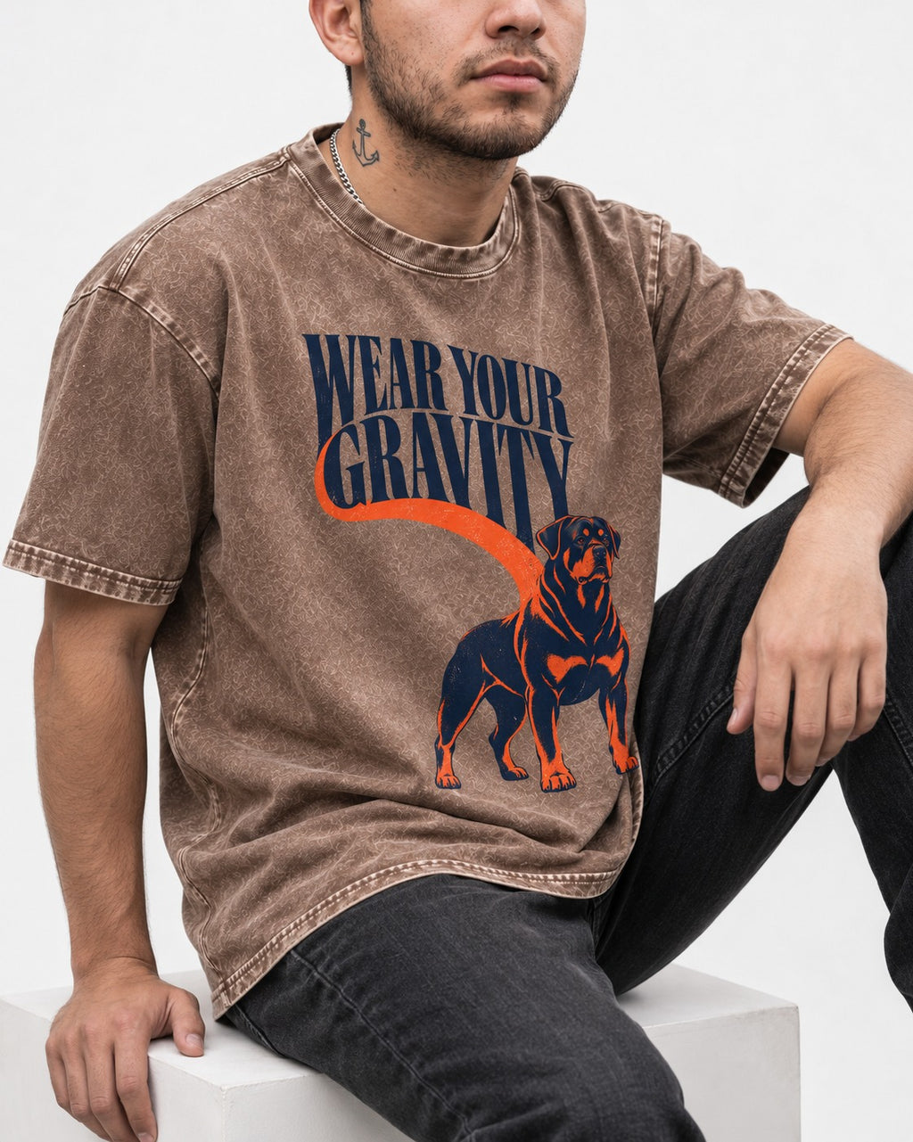 Wear Your Gravity Rottweiler Washed Tee in Coffee, worn by a seated model