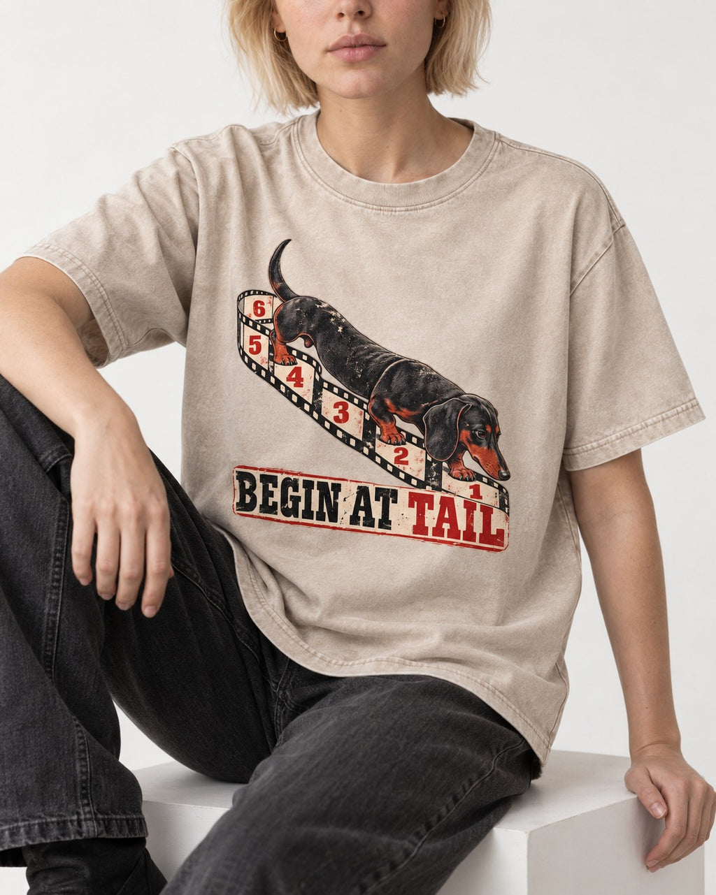 Begin at Tail Dachshund Washed Tee in Apricot, worn by a seated model