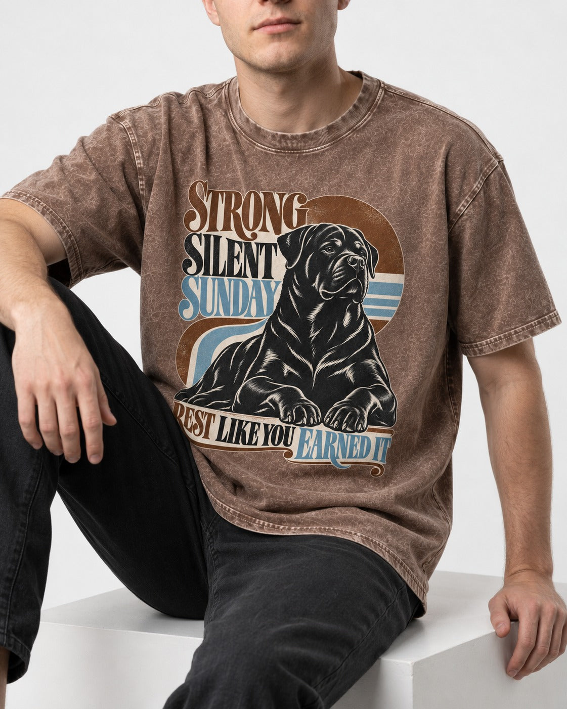 Strong Silent Sunday Rottweiler Washed Tee in Coffee, worn by a seated model