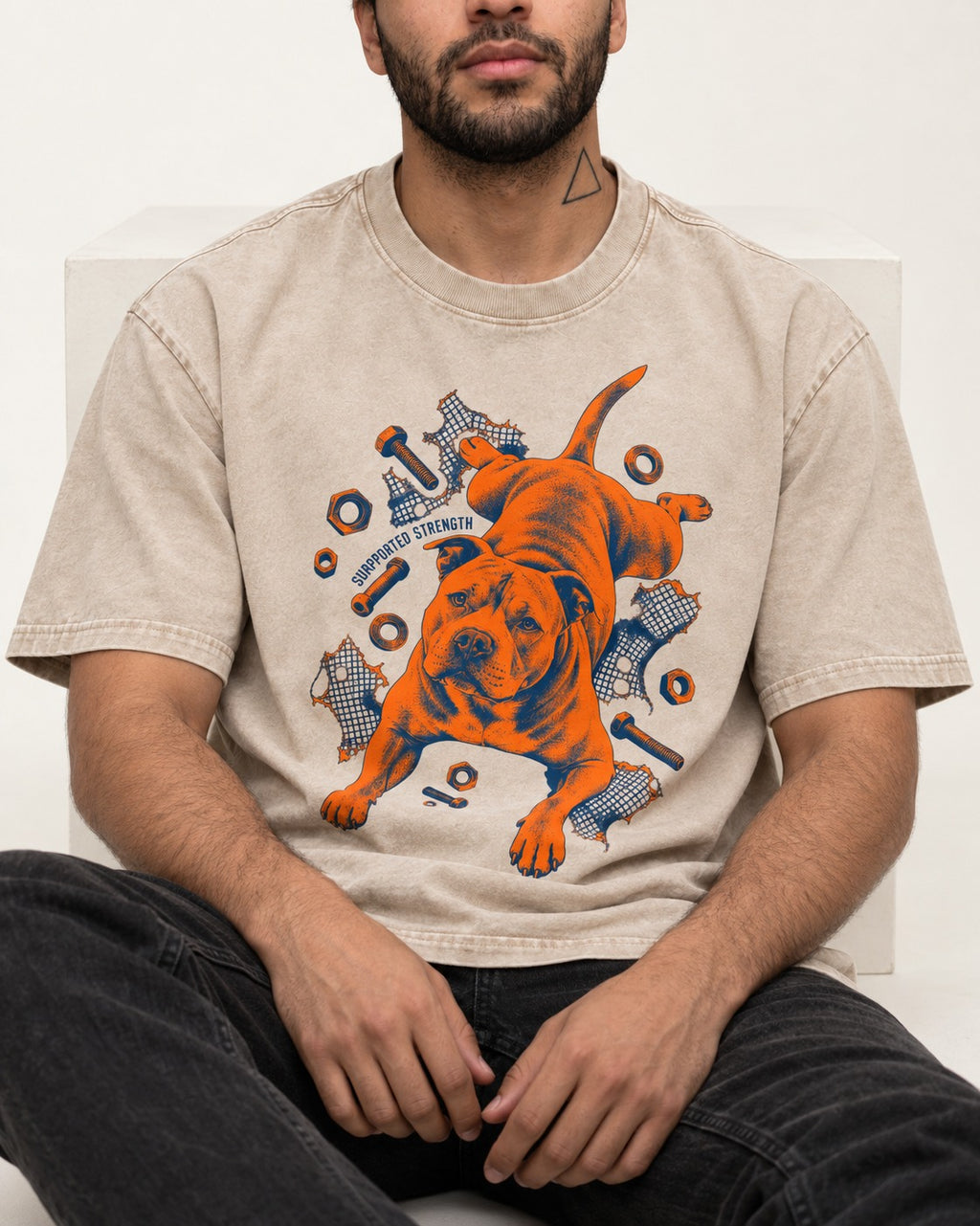 Pitbull Strength Washed Tee in Apricot, worn by a seated model