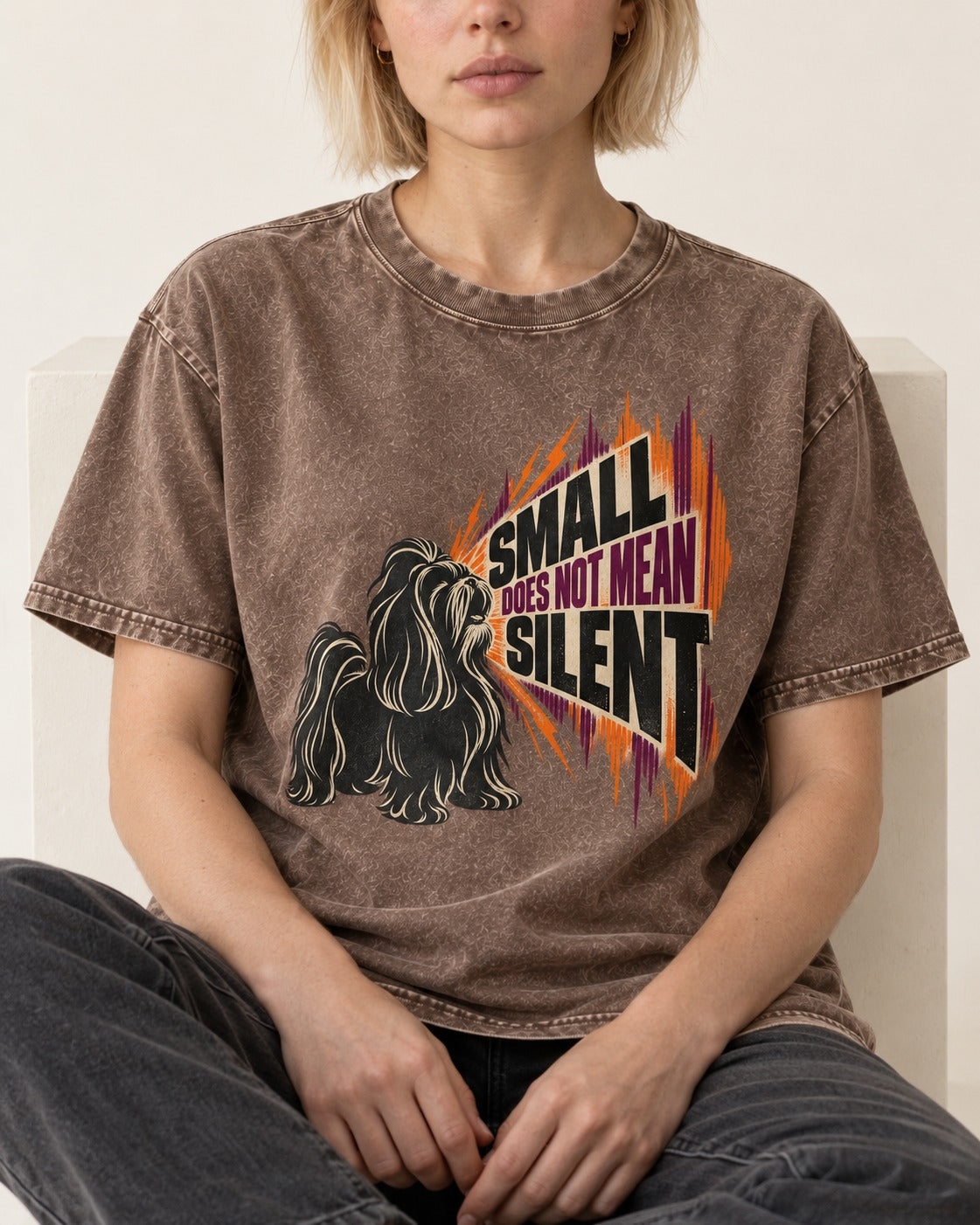 Small Not Silent Shih Tzu Washed Tee in Coffee, worn by a seated model