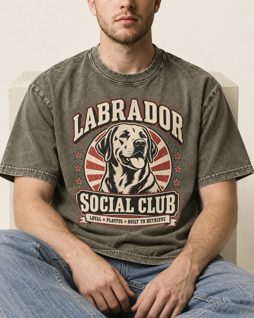 Labrador Retriever Social Club Loyal Playful Built to Retrieve Badge Graphic Washed Tee in Army Green, worn by a seated model