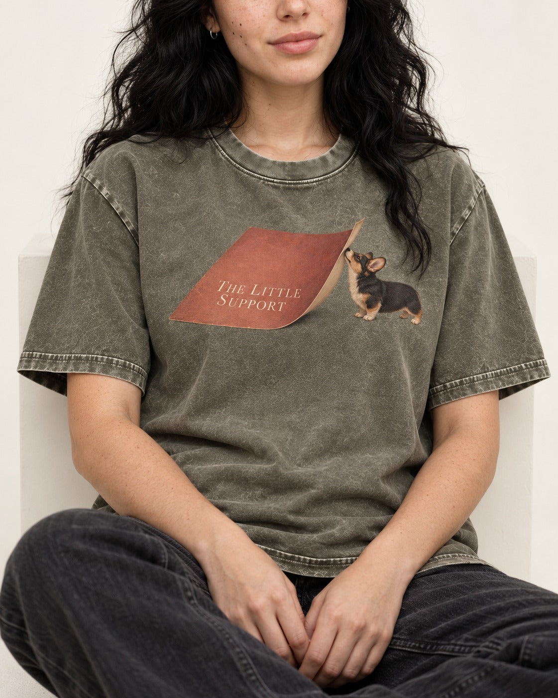 Corgi The Little Support Paper Graphic Washed Tee in Army Green, worn by a seated model