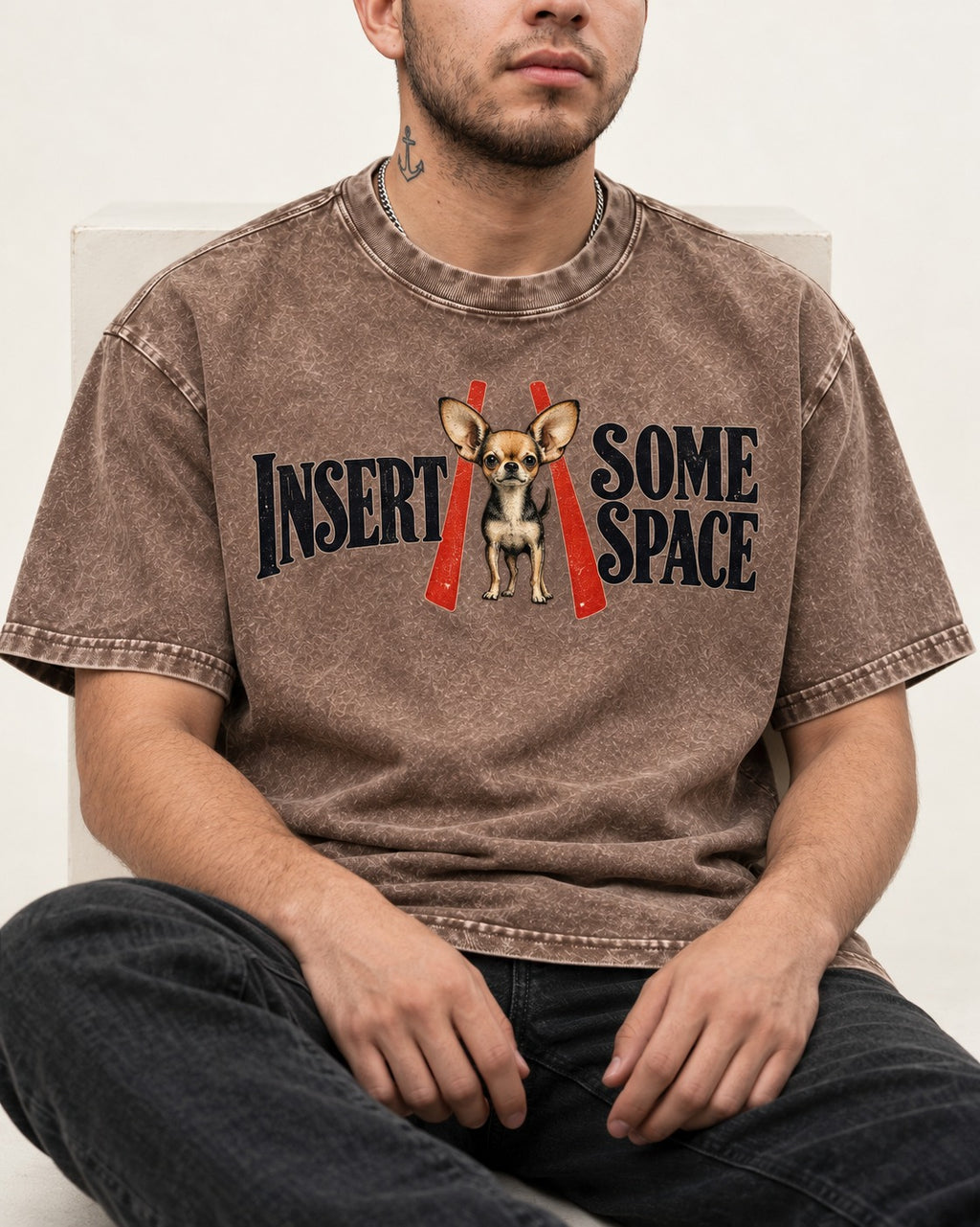 Insert Some Chihuahua Space Washed Tee in Coffee, worn by a seated model