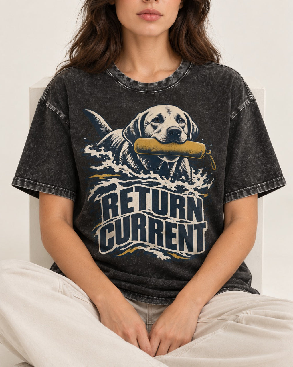 Return Current Water Retrieve Labrador Retriever Graphic Washed Tee in Black, worn by a seated model