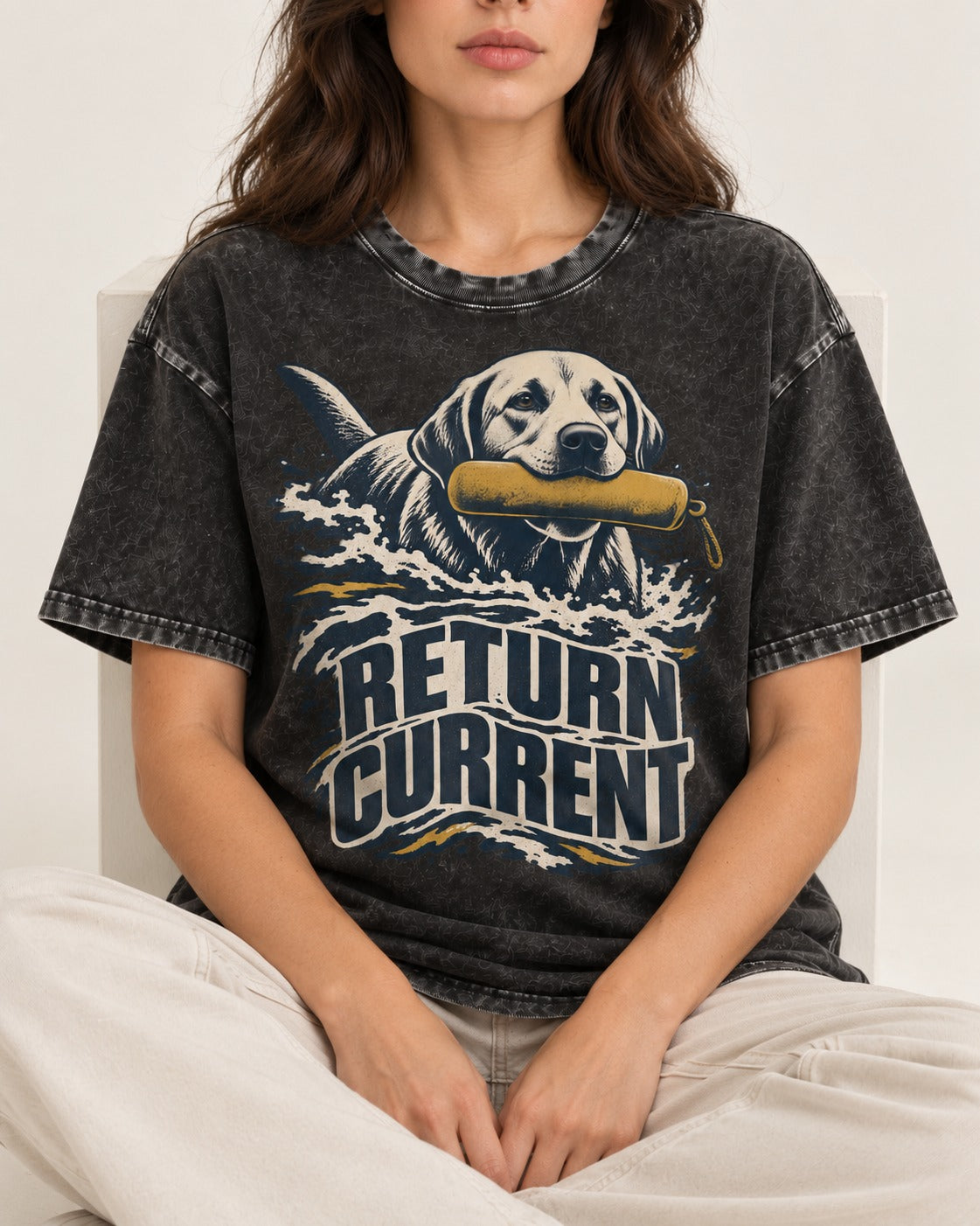 Return Current Water Retrieve Labrador Retriever Graphic Washed Tee in Black, worn by a seated model
