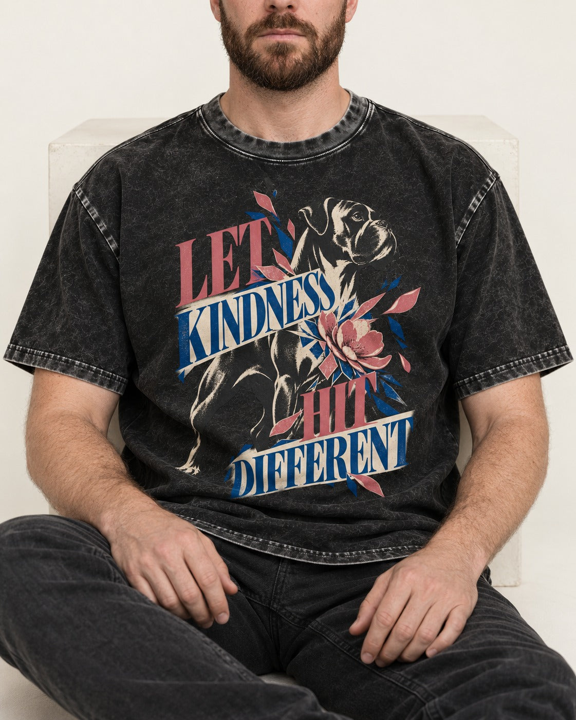 Let Kindness Hit Different Boxer Floral Collage Washed Tee in Black, worn by a seated model