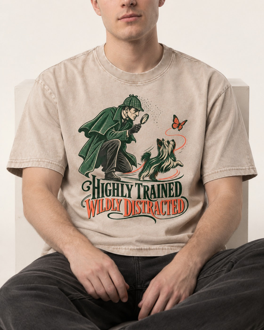 Highly Trained Wildly Distracted Yorkshire Terrier Washed Tee in Apricot, worn by a seated model