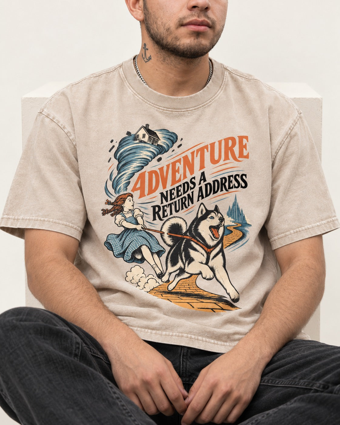 Husky Needs a Return Address Washed Tee in Apricot, worn by a seated model