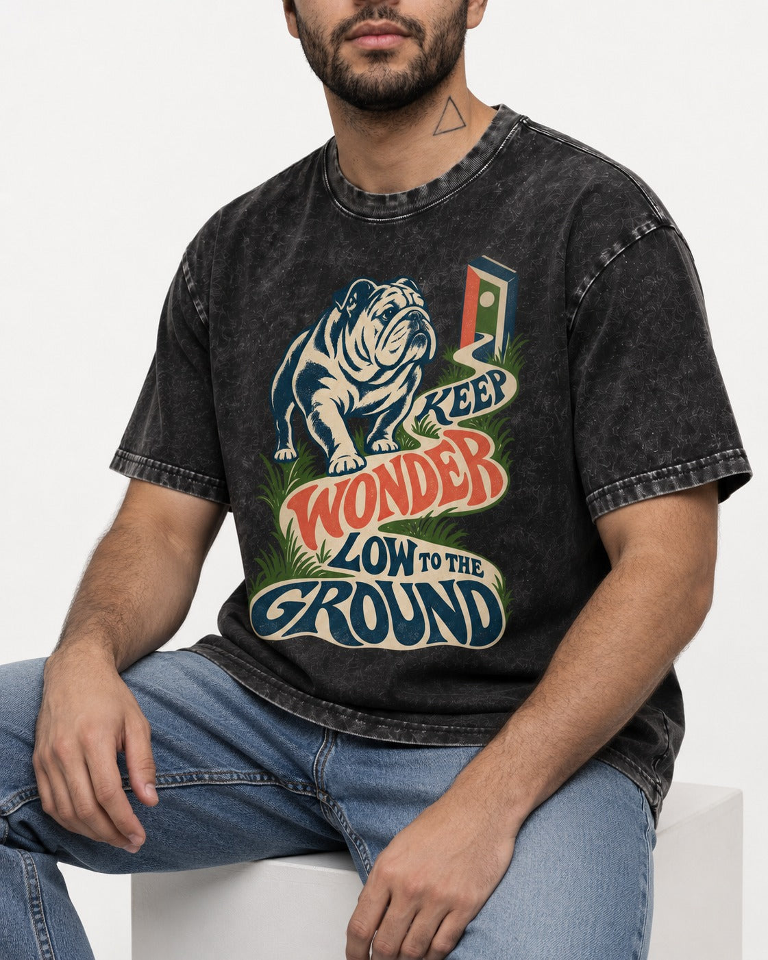 Keep Wonder Low to the Ground English Bulldog Graphic Washed Tee in Black, worn by a seated model