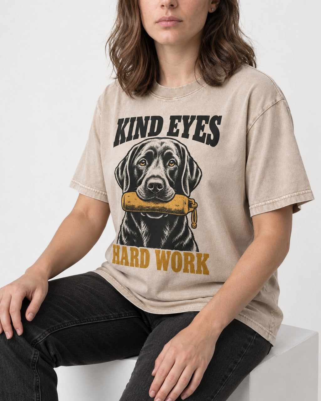 Kind Eyes Hard Work Labrador Retriever Washed Tee in Apricot, worn by a seated model