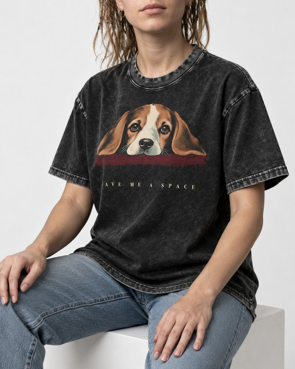Save Me A Space Beagle Washed Tee in Black, worn by a seated model