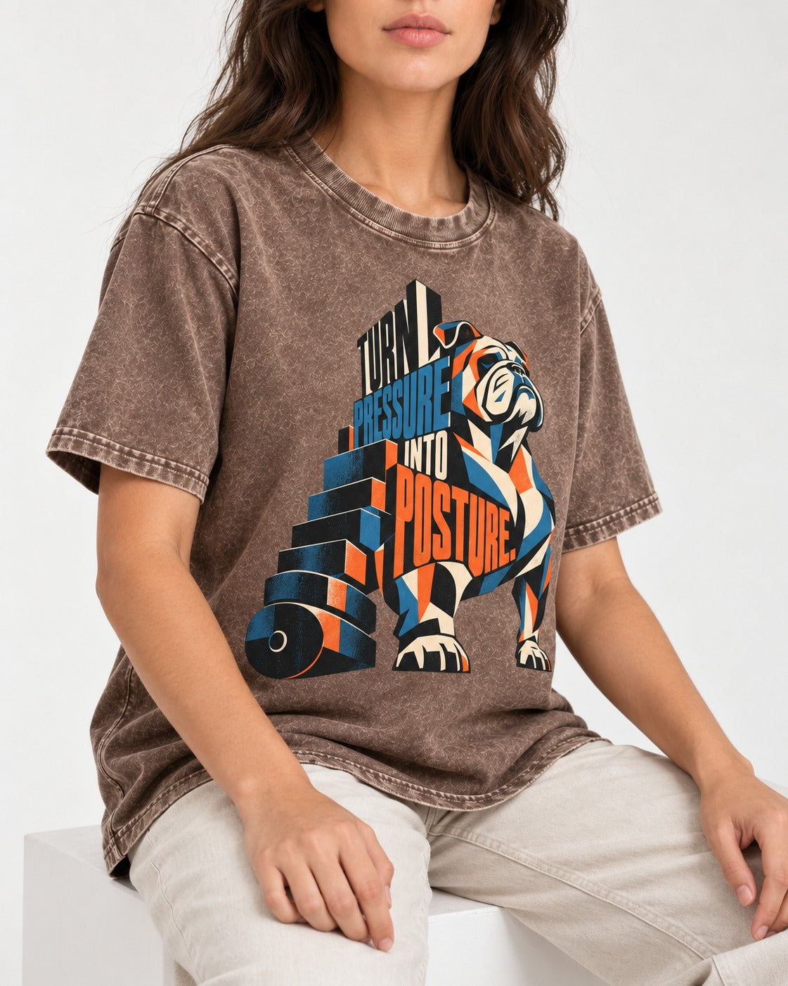 Turn Pressure Into Posture English Bulldog Washed Tee in Coffee, worn by a seated model