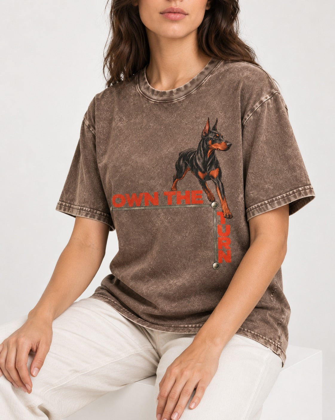 Own the Turn Doberman Washed Tee in Coffee, worn by a seated model