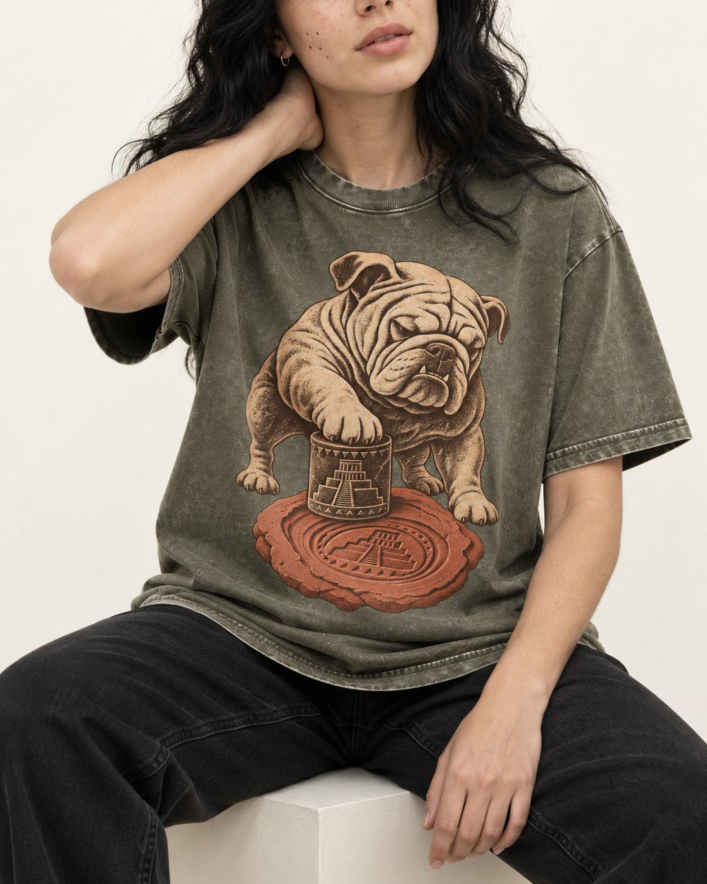 English Bulldog Ancient Cylinder Seal Graphic Washed Tee in Army Green, worn by a seated model