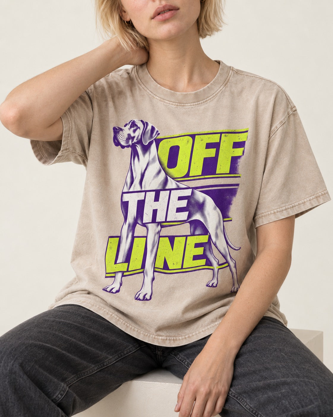 Great Dane Off the Line Washed Tee in Apricot, worn by a seated model