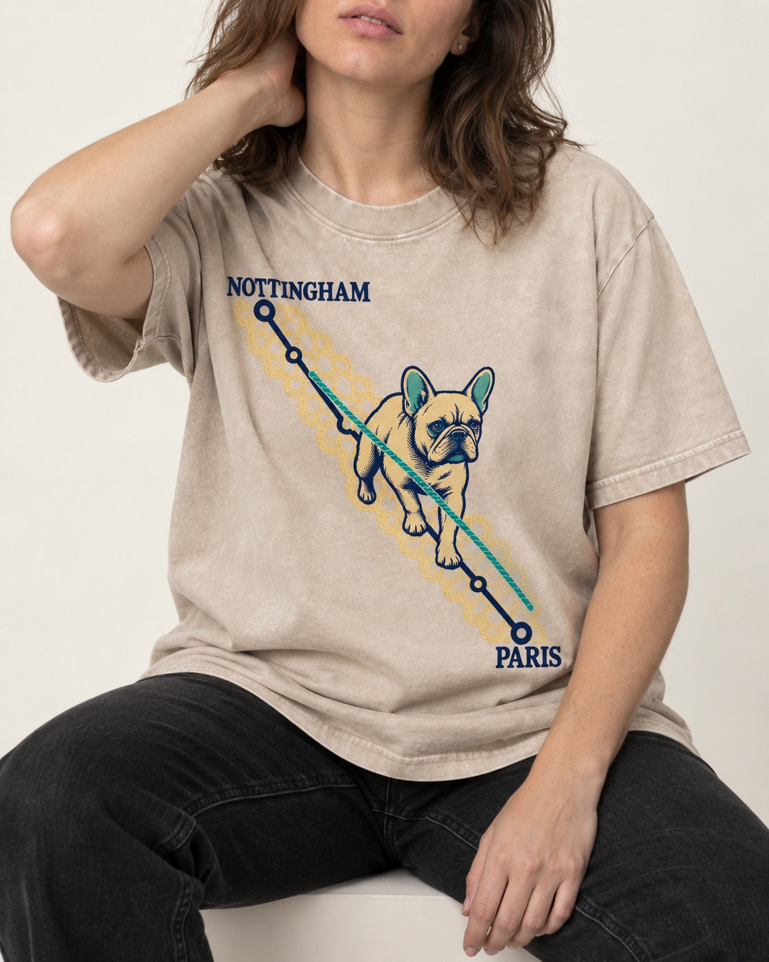 Nottingham to Paris Frenchie Washed Tee in Apricot, worn by a seated model