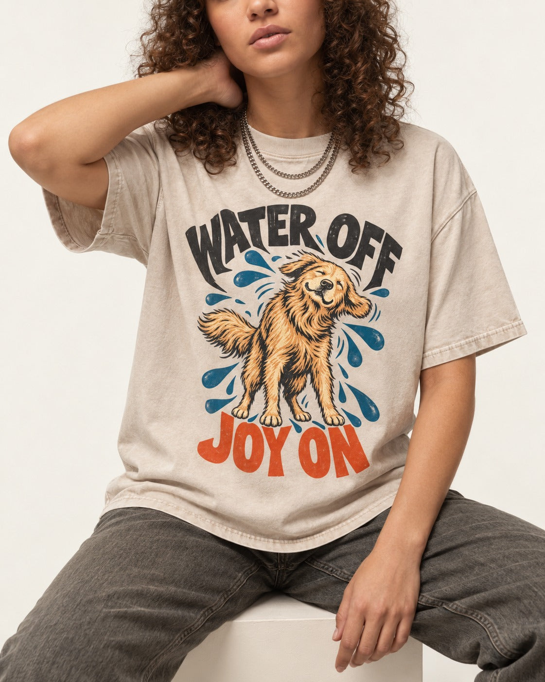 Water Off Joy on Golden Retriever Washed Tee in Apricot, worn by a seated model