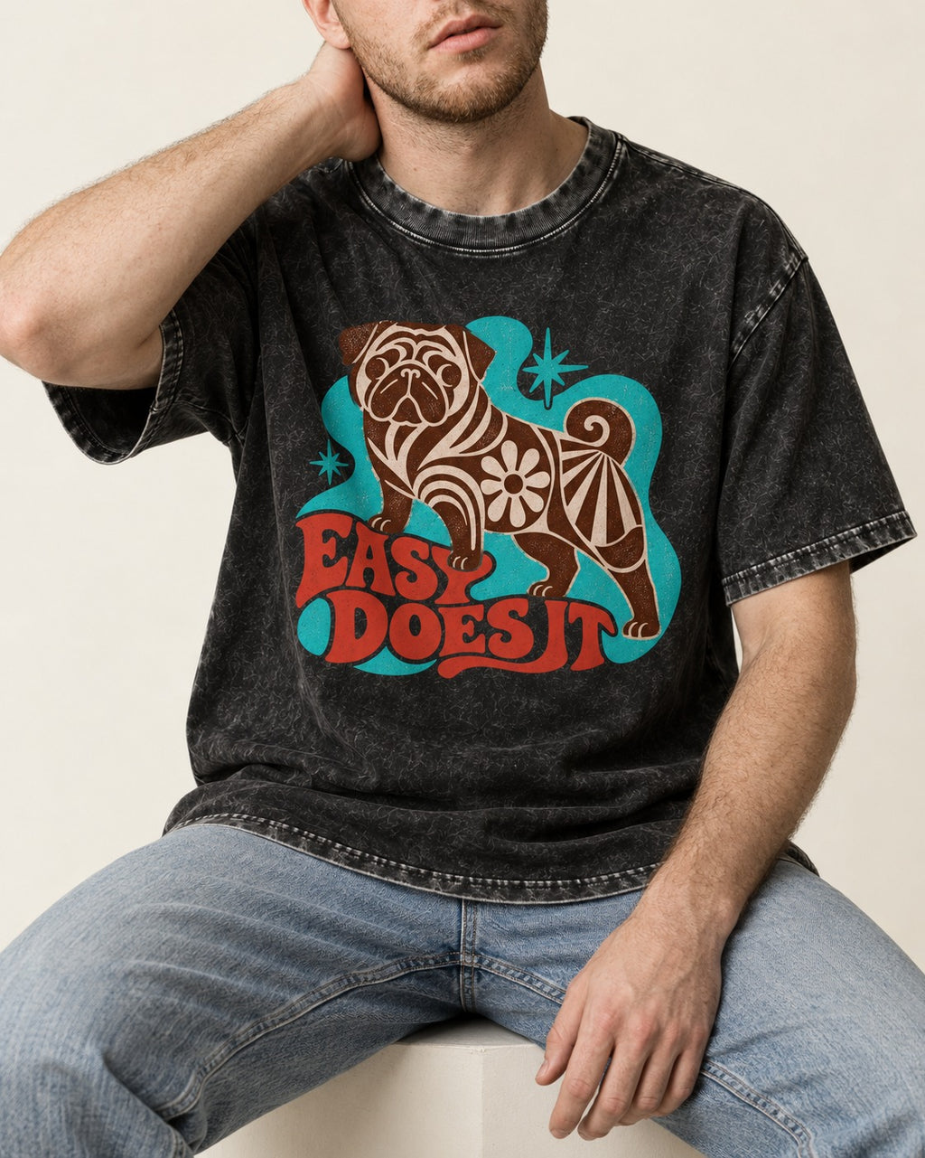 Pug Easy Does It Retro Floral Graphic Washed Tee in Black, worn by a seated model