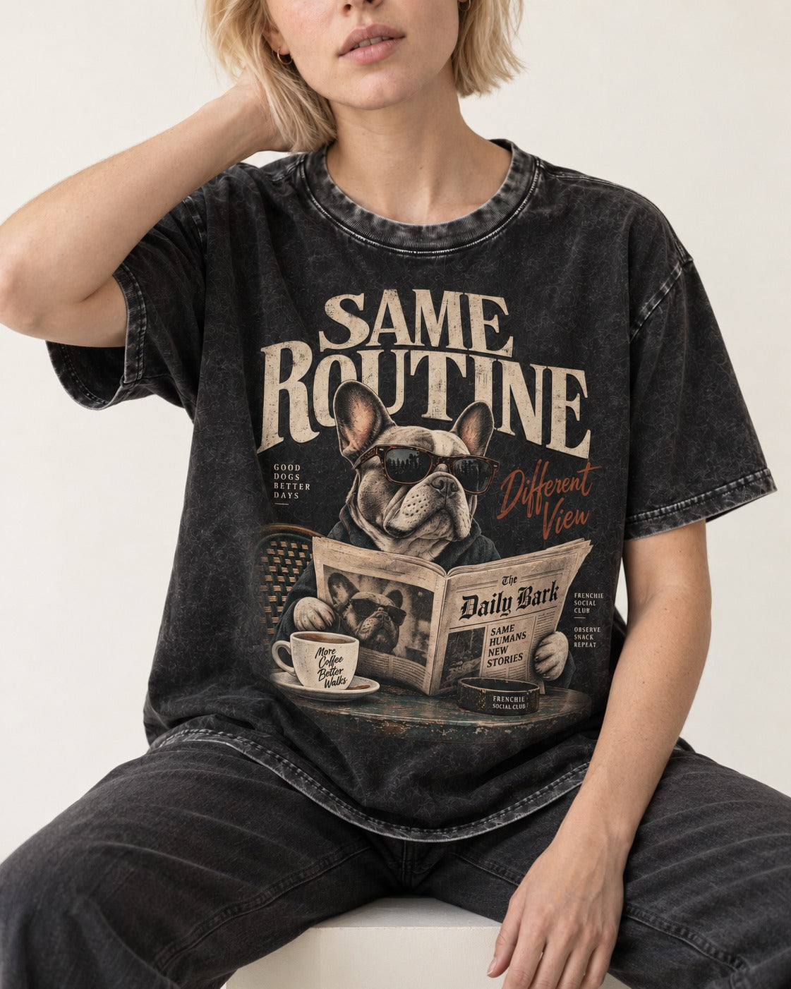 Frenchie Same Routine Different View Graphic Washed Tee in Black, worn by a seated model