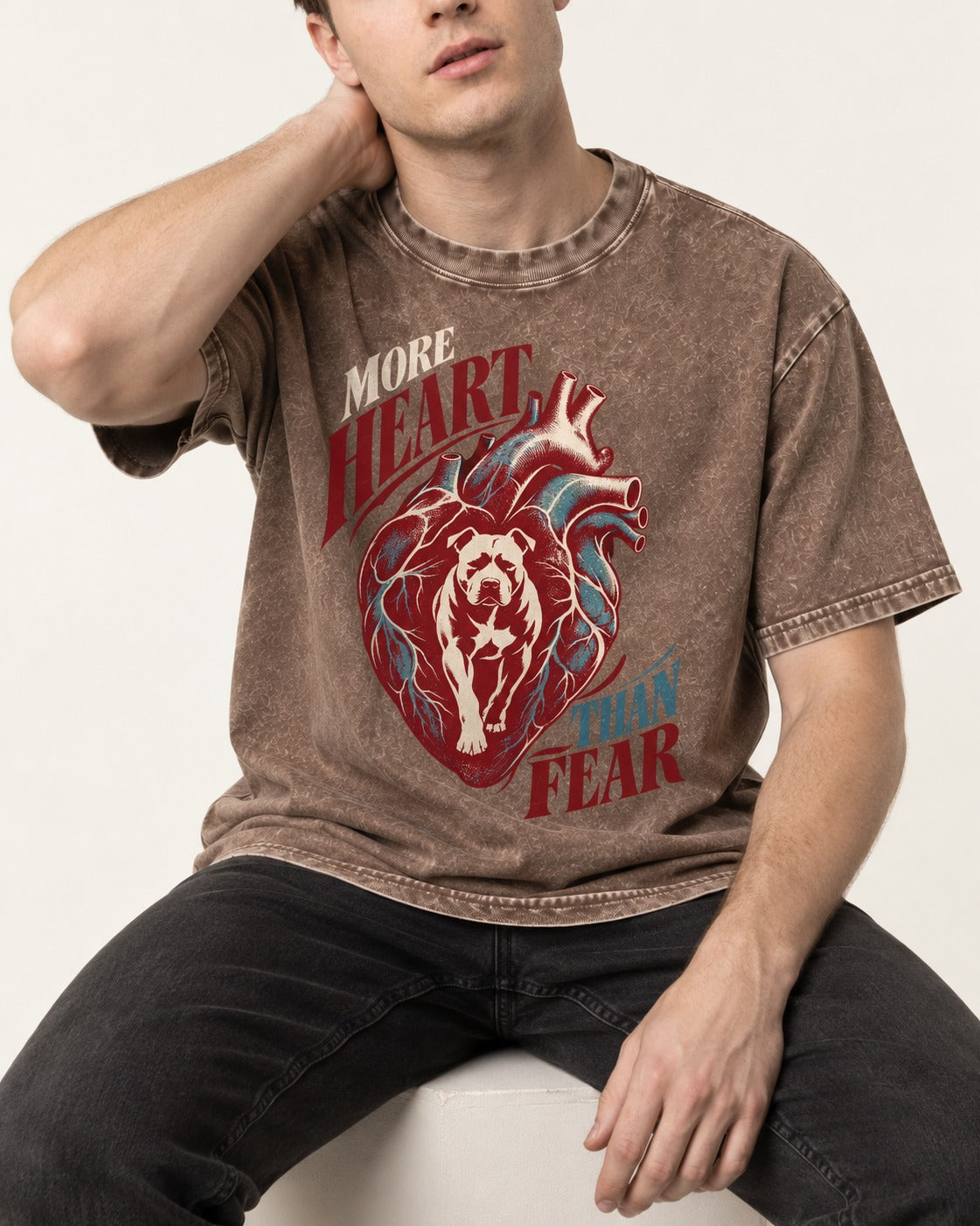 Pitbull More Heart Than Fear Anatomical Heart Graphic Washed Tee in Coffee, worn by a seated model