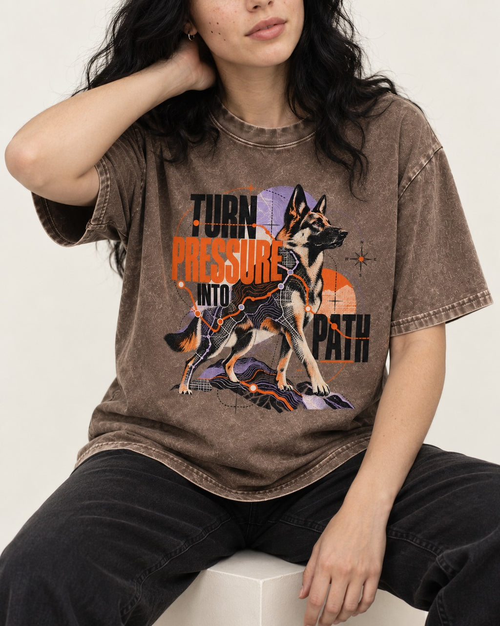 Turn Pressure Into Path German Shepherd Dog Washed Tee in Coffee, worn by a seated model