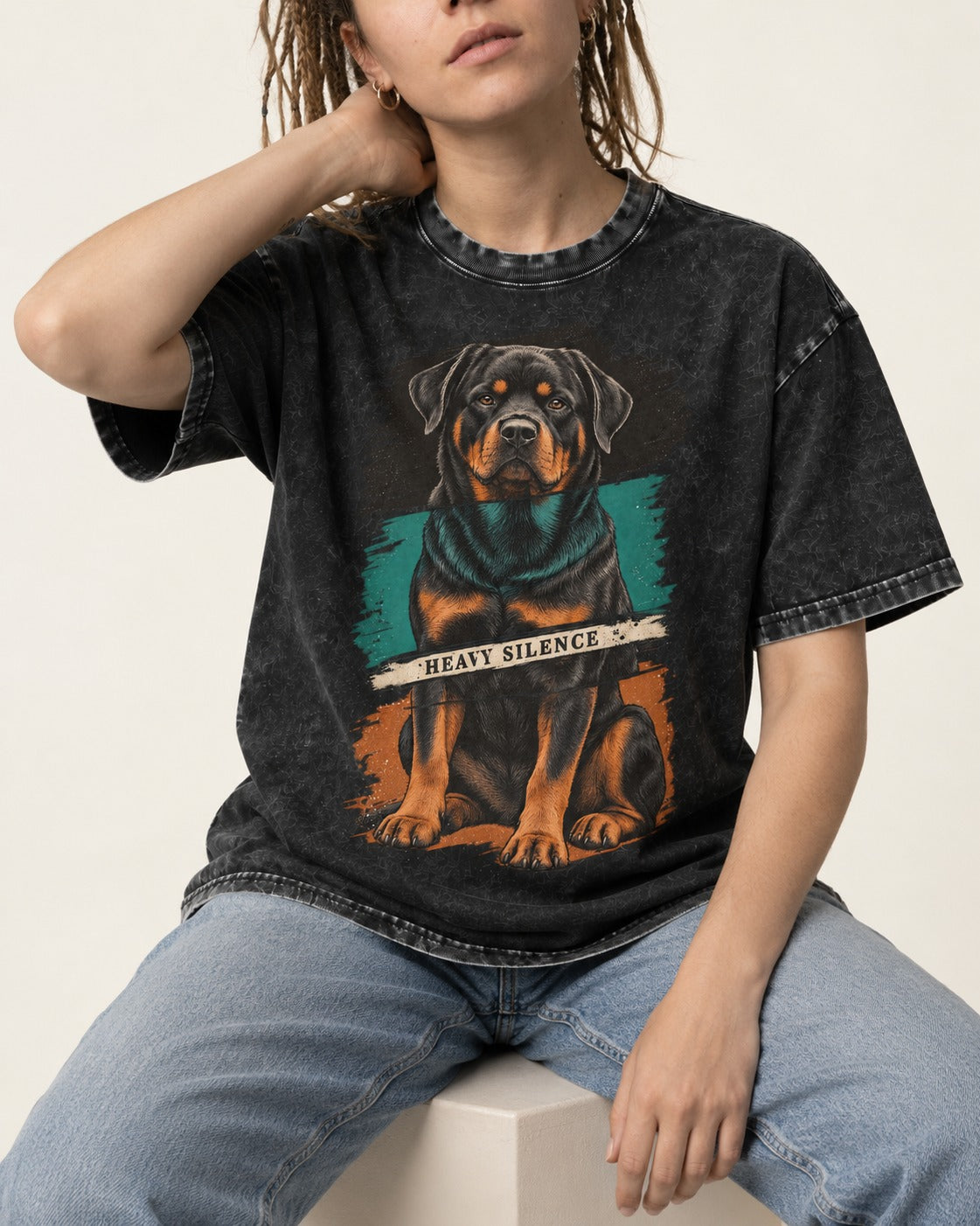 Rottweiler Heavy Silence Brushstroke Portrait Graphic Washed Tee in Black, worn by a seated model